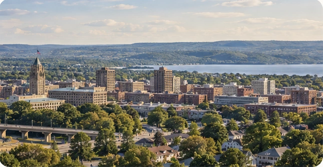 Illustrative panoramic composition of the Syracuse skyline and surrounding Central New York landscape from the approved V2 Local Opportunity design.